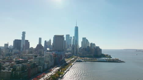 Elevated-view-of-downtown-skyscrapers-in-Financial-district-against-sunshine.-One-World-Trade-Center-towering-above-other-high-rise-buildings.-Manhattan,-New-York-City,-USA