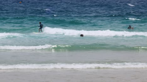 Multiple surfers catch waves in vibrant ocean