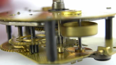 clockwork mechanism of retro clock rotating cogwheels gears close up