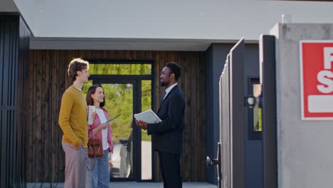 real estate agent showing a house to a couple