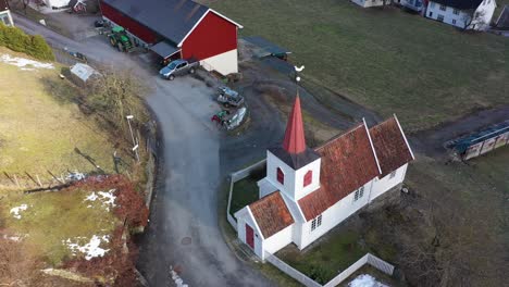 europes smallest stave church in undredal norway - beautiful aerial rotating and descending around church during morning sunrise