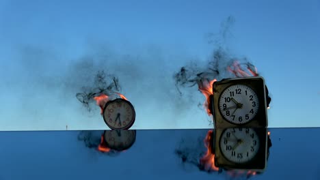 time is a fire. burning  two old  alarm clocks on mirror