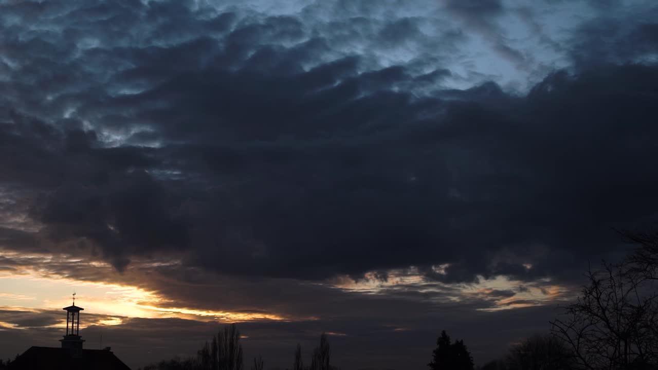stratocumulus dark cloud at sunset sky time lapse sun rays