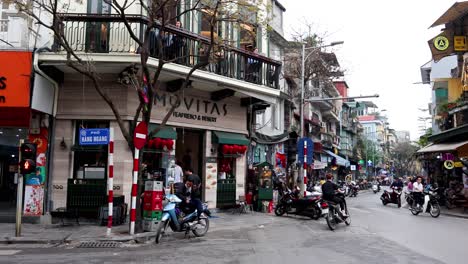 motorbikes and cars on a bustling street