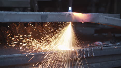 plasma cutter cuts metal in an industrial company - high energy through heat and electrical power - special tools in the metal industry - sparks and fire in high resolution 4k shot - close up