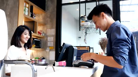 asian people using smartphone for buy coffee