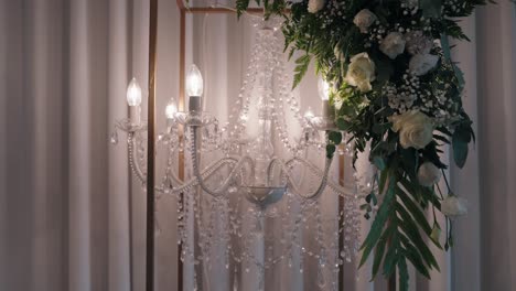 elegant crystal chandelier with floral decor and soft lighting ambiance