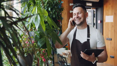 florist talking on phone and using tablet