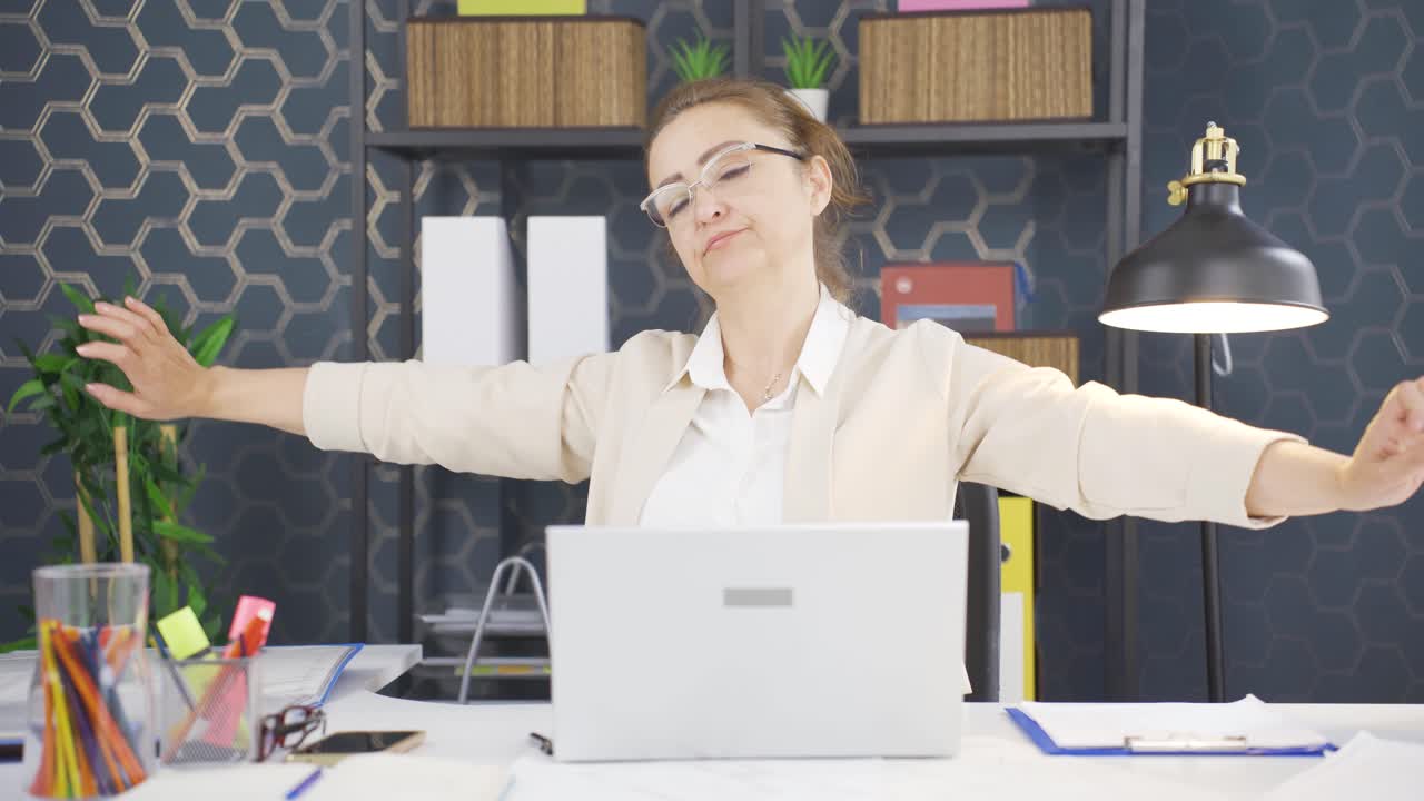 Sleepy business woman yawns looking at camera.