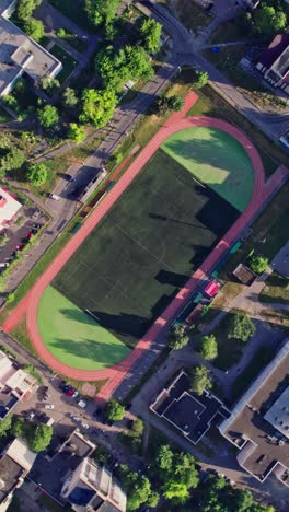con edificios en la calle en una pequeña ciudad con campo de fútbol vacío