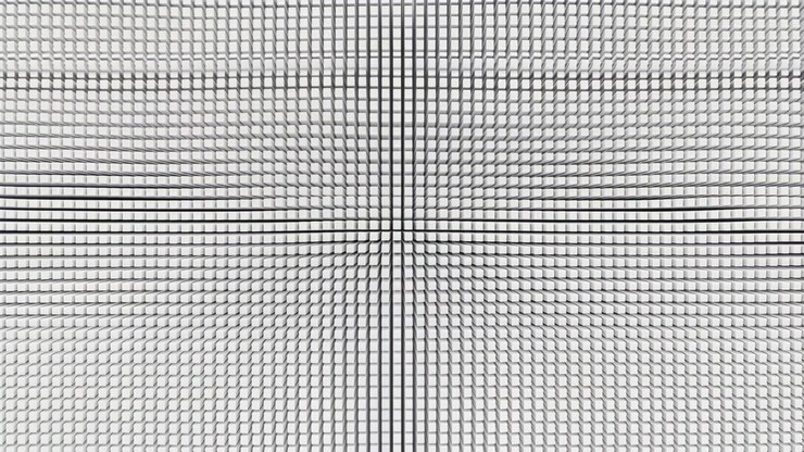 Dense rows of raised white tiles subtly shift around the center, creating a wave-like perspective pattern with balanced symmetry, crisp edges, layered depth, and neutral lighting.