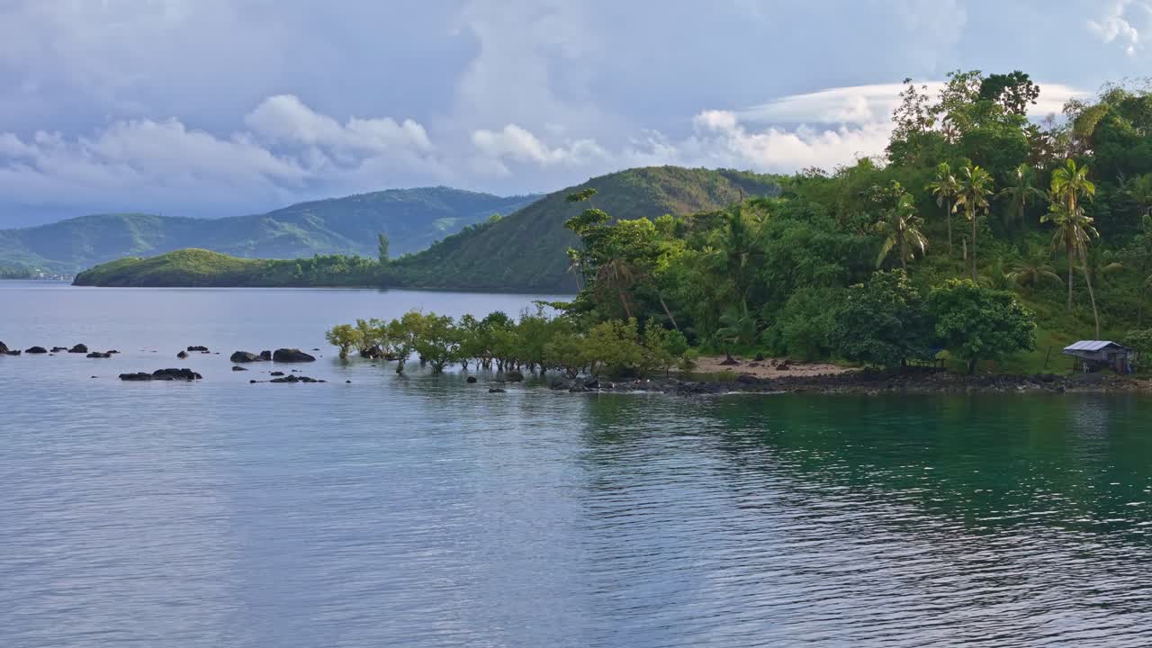Dinagat island mountains, lush tropical forests under rainy sky, Drone shot