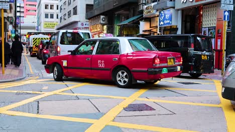 taxis and pedestrians navigate a bustling intersection