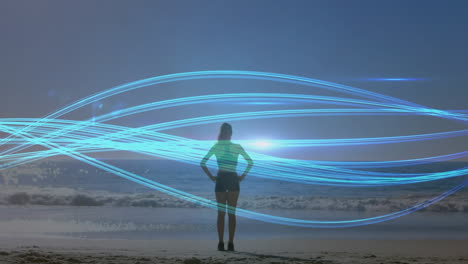 animation of blue lines over caucasian woman praciticing yoga on beach