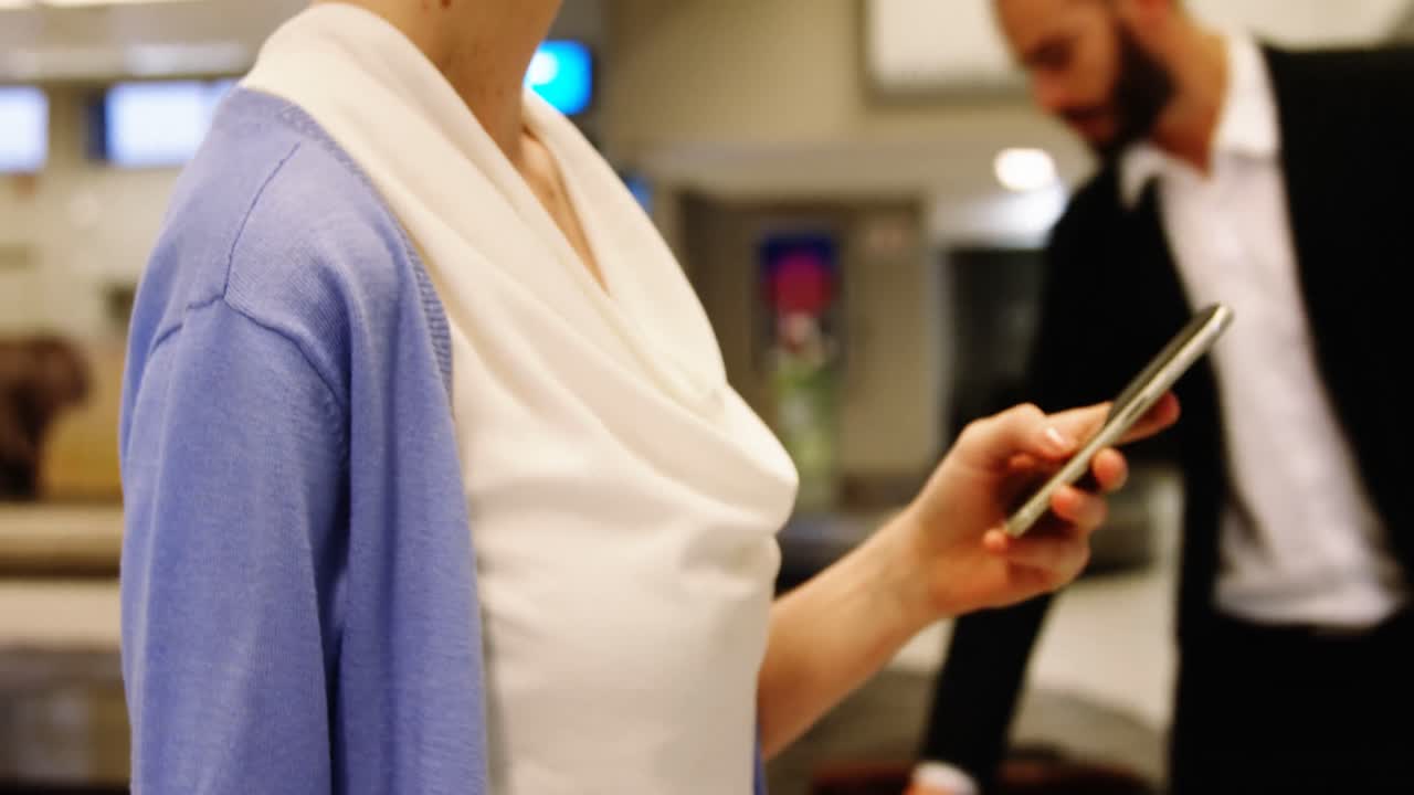 Female passenger using mobile phone