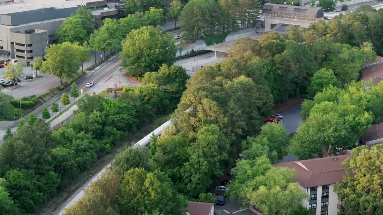 Aerial view of a freight train crossing through residential housing neighbourhood in Atlanta Buckhead