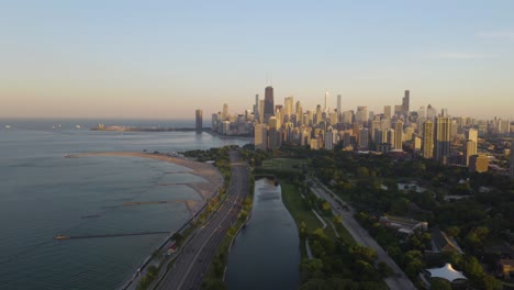 closing shot - drone flies away from downtown chicago on summer evening