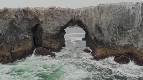 Aerial-fly-through-of-a-large-arch-in-the-Pacific-Ocean-near-the-Sonoma-Coast-in-California