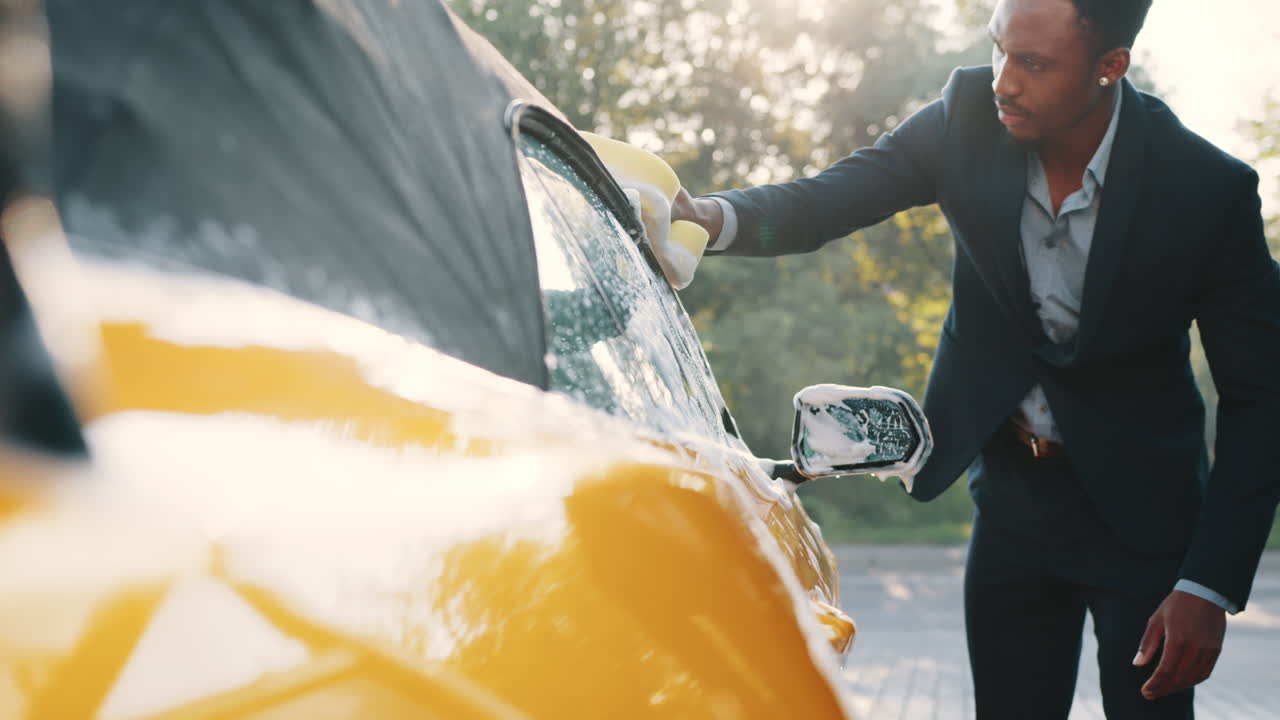 노란색 컨버터블 자동차를 는 남자