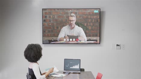 African-american-businesswoman-on-video-call-with-caucasian-male-colleague-on-screen