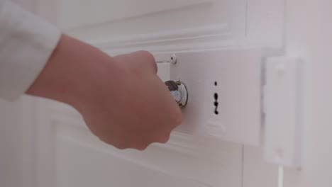 Woman&#039;s hand trying to open a locked door
