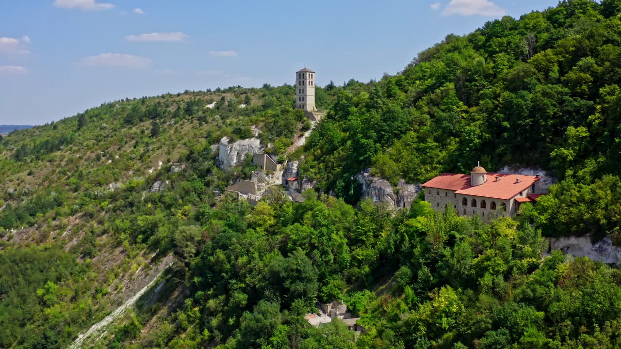 Historical architecture located on hills. Panoramic view of buildings in the mountains with green areas in summer. Aerial view.