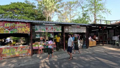 people shopping at vibrant outdoor market stalls