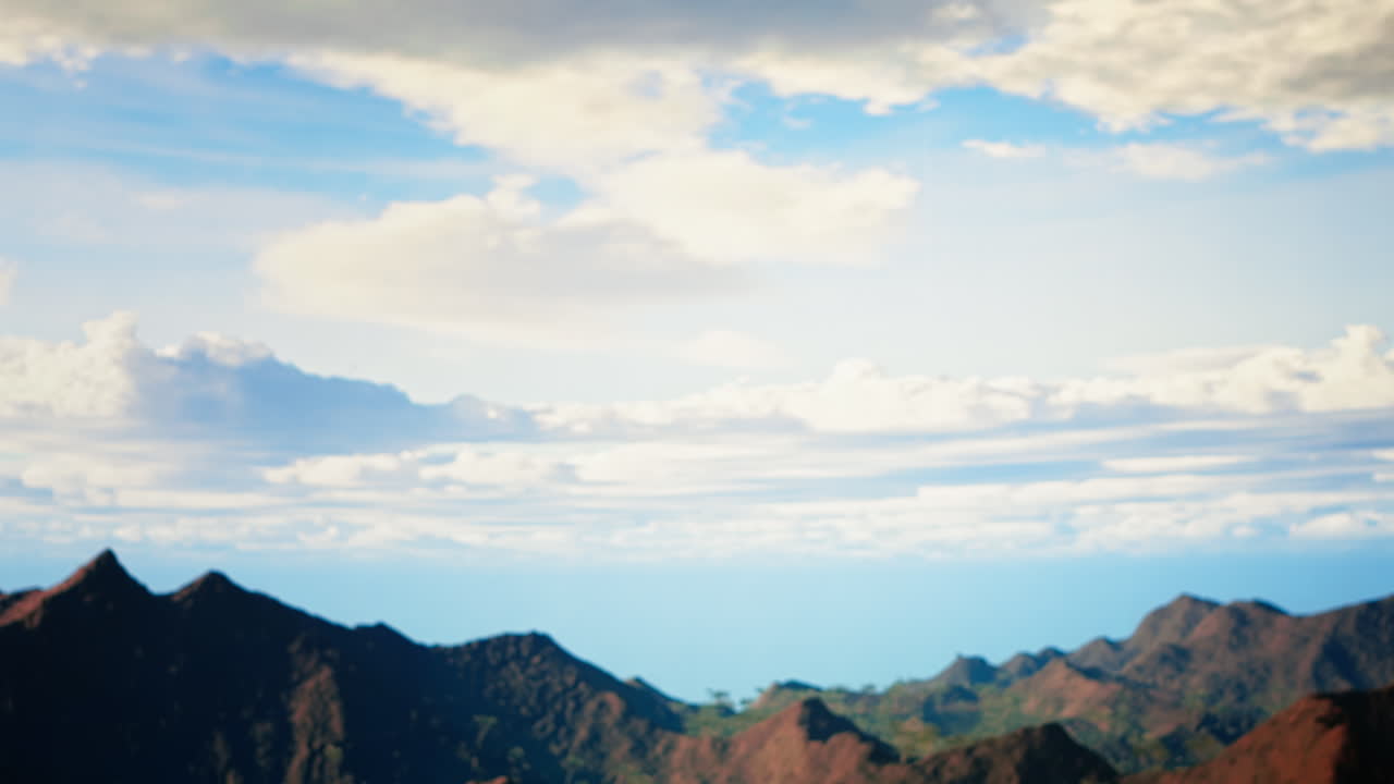 어색한 여행자는 강한 바람에 의해 산꼭대기에 균형을 잃습니다.