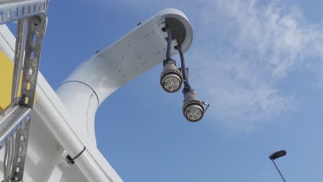 high voltage charging cables for electric ferryboat hanging from tower - low angle handheld with blue sky background