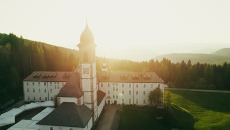 aerial view of a monastery in the mountains at sunset