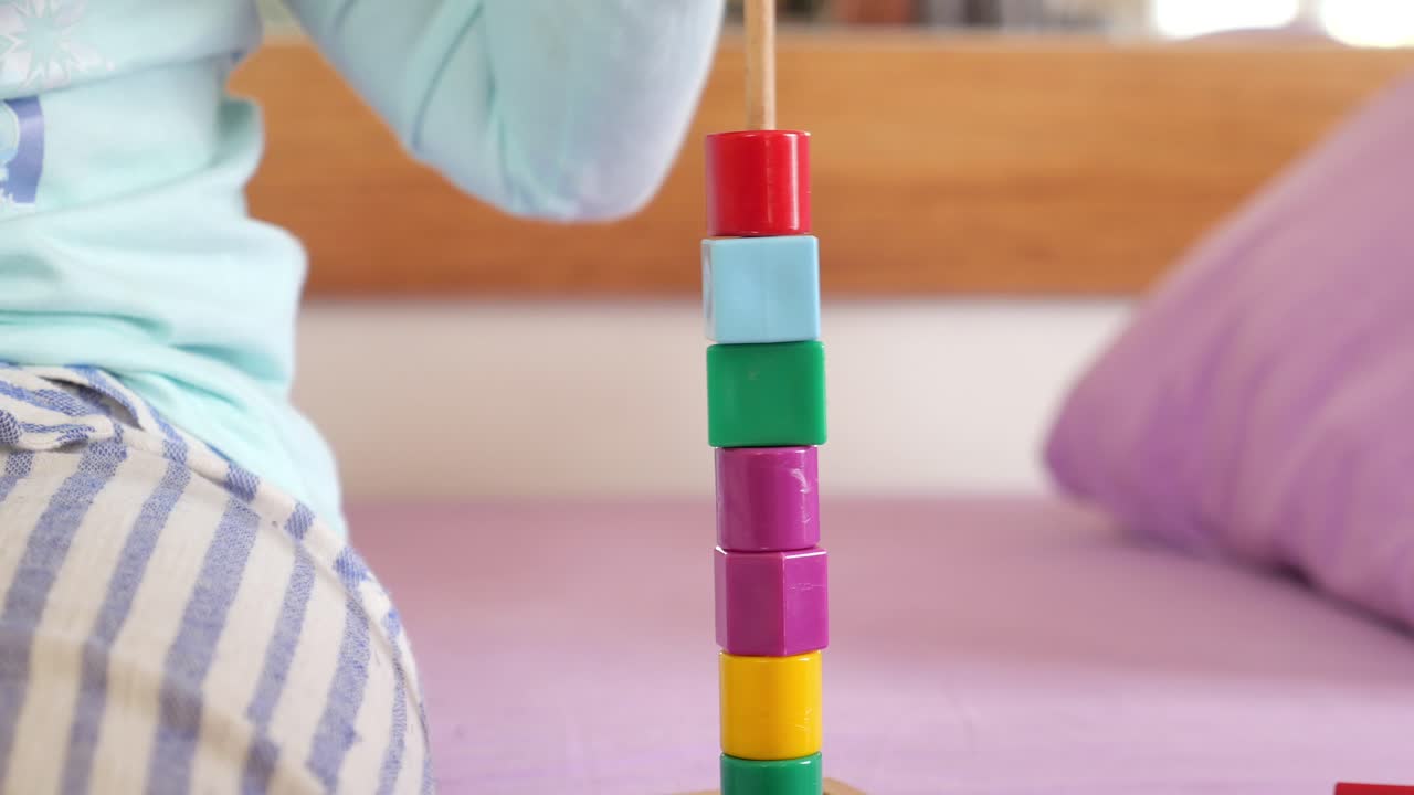 Young Girl Playing with Colorful Blocks