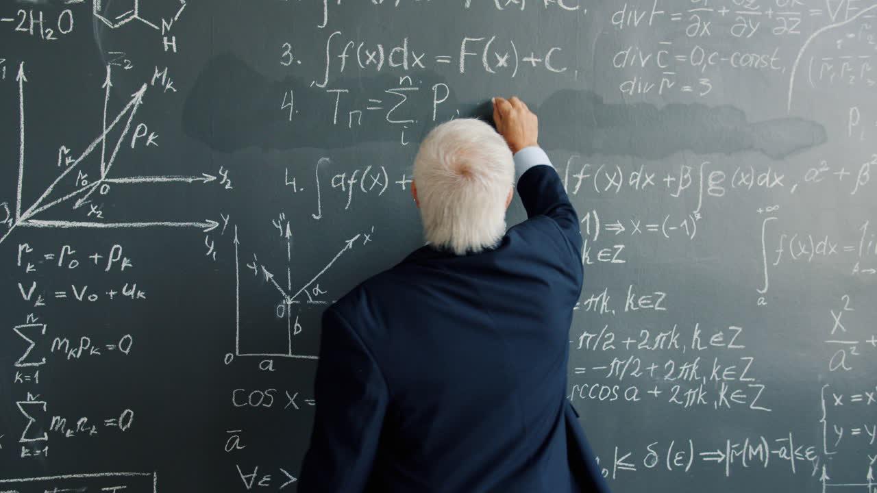 Professor Writing Equations on a Blackboard