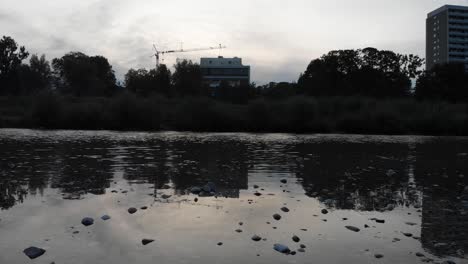 Calm-river-shoot-with-flowing-water-and-rocs-from-a-low-angle-in-the-afternoon-at-4k-24fps