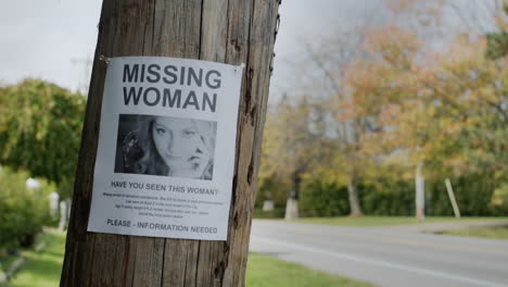 Poster-for-a-missing-young-woman-hangs-on-a-pole-near-the-road