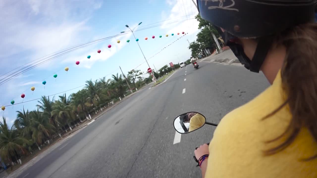 Girl riding a moped on the way to the next destination