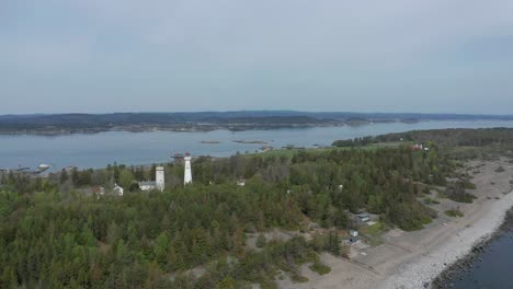 Aerial-of-the-Jomfruland-Lighthouse-It-is-a-coastal-lighthouse-located-on-the-island-of-Jomfruland-in-Kragerø,-Norway