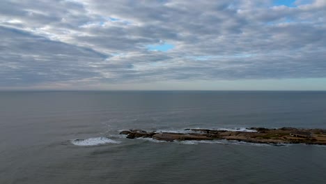 drone advancing the rock on the ocean shore on uruguay