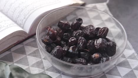 dates in a bowl with a quran