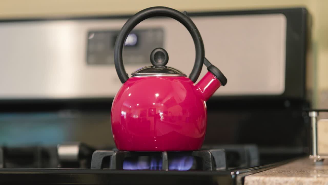 Tea kettle heating up on a stove top