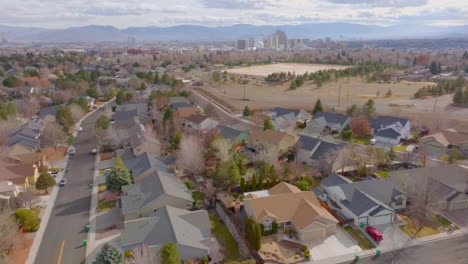 pull away from city of reno and mountain range and over suburban houses and neighborhood