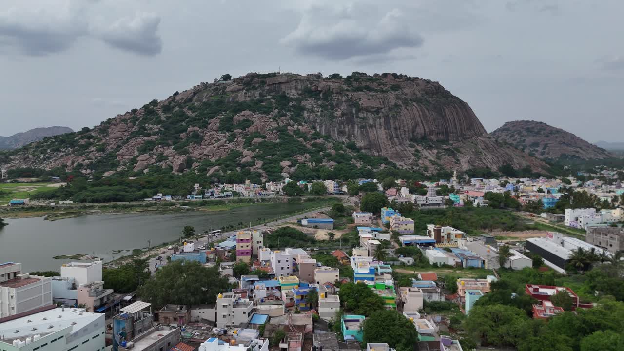 Aerial View of a Colorful Town at the Foot of a Rocky Mountain with a Lake