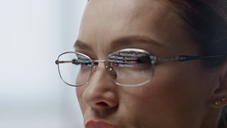 developer glasses reflecting code lines closeup. woman hacker programming app