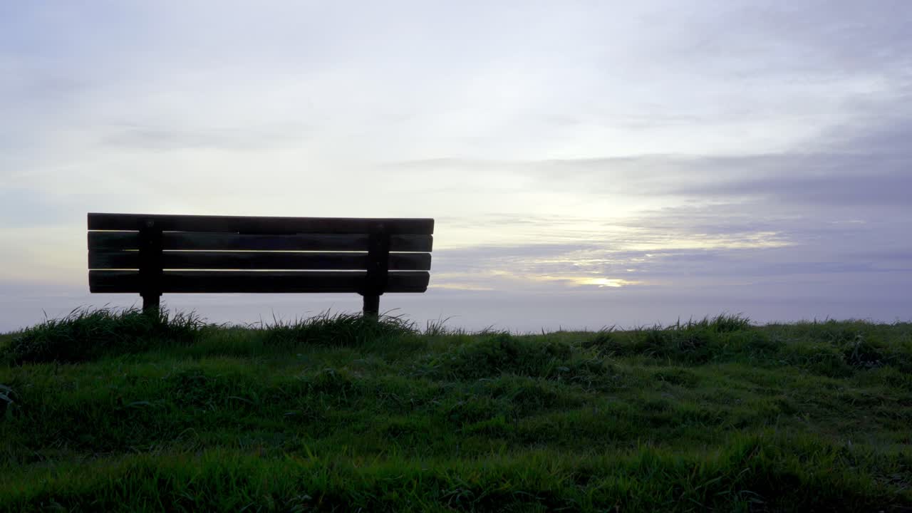 Serene Sunset View from a Bench Overlooking the Ocean