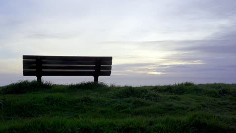 serene sunset view from a bench overlooking the ocean