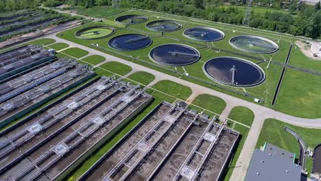 sewage farm. static aerial photo looking down onto the clarifying tanks and green grass.