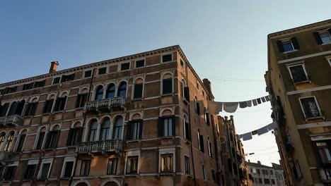 venetian houses with hanging clothes in venice downtown in italy, panning