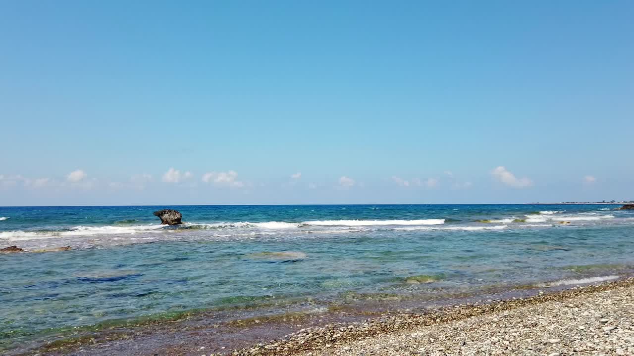 Waves crash against rocks in the sea and along the shore at Mandria Beach, Cyprus. A raw, beautiful moment showing nature’s rhythm—ideal for coastal, travel, or relaxation themes.