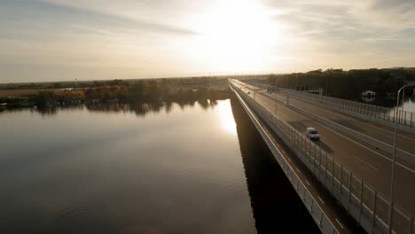 An-aerial-FPV-drone-backlit-footage-of-a-tranquil-riverbank-lined-with-colorful-houseboats