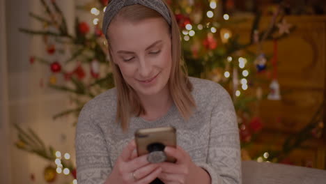 Young-Woman-Browsing-Internet-On-Smartphone-At-Home-1