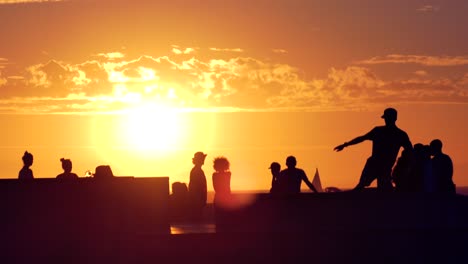 sunset silhouettes of people on a beach